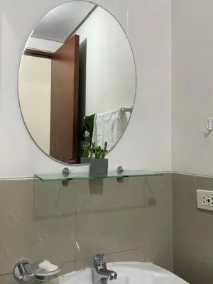 a bathroom with a mirror and a sink at Makati Cozy Studio Apartment in Manila