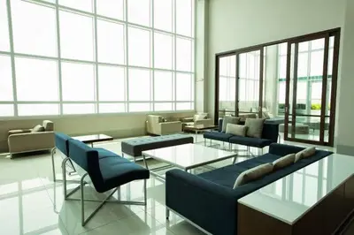 a living room with couches and tables and windows at Makati Cozy Studio Apartment in Manila