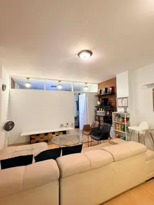 a living room with a couch and a table at Cinema room at Intramuros by IN cafebar in Manila