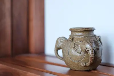 a brown vase sitting on a wooden floor at One bedroom budget condo in BGC in Manila