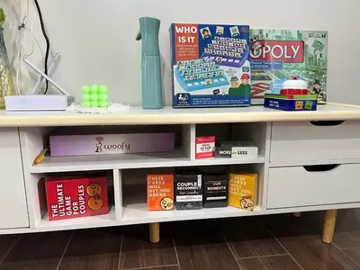 a book shelf with books on it at Cozy Condo Apartment in Makati / Manila with mall, restaurants, groceries, pool, netflix, disney+ and more in Manila