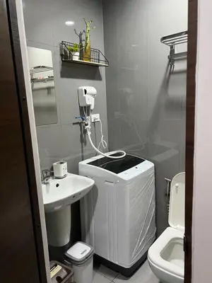 a small bathroom with a toilet and a sink at Cozy Condo Apartment in Makati / Manila with mall, restaurants, groceries, pool, netflix, disney+ and more in Manila