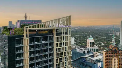a tall building with the word colazon on top of it at Oakwood Makati Avenue in Manila