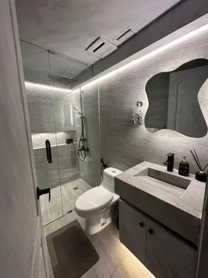 a bathroom with a toilet and a sink and a shower at Condo in Taguig, 2br condo, Acacia Estates, BGC, in Manila