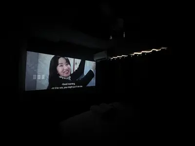 a woman on a television screen in the dark at Condo in Taguig, 2br condo, Acacia Estates, BGC, in Manila