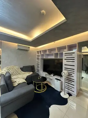 a living room with a couch and a television at Condo in Taguig, 2br condo, Acacia Estates, BGC, in Manila