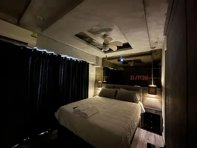 a bedroom with a bed with a ceiling fan at Condo in Taguig, 2br condo, Acacia Estates, BGC, in Manila