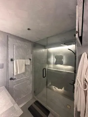 a bathroom with a shower with a glass door at Condo in Taguig, 2br condo, Acacia Estates, BGC, in Manila