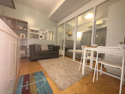 a living room with a table and a couch at DFT Apartment 