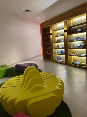 a yellow bean bag chair in a room with a closet at DFT Apartment 