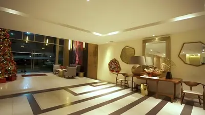 a living room with a christmas tree and a table at DFT Apartment 
