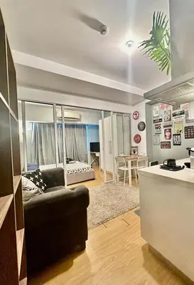 a living room with a couch and a table at DFT Apartment 