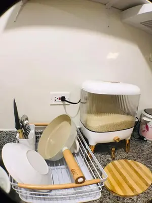 a kitchen counter with a dish drying rack and a food processor at Spring Residences Affordable Condotel Bicutan Paranaque near NAIA Airport in Manila