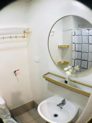 a bathroom with a sink and a mirror at Spring Residences Affordable Condotel Bicutan Paranaque near NAIA Airport in Manila