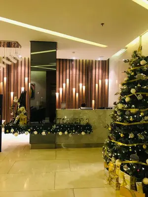 a christmas tree in the middle of a lobby at Spring Residences Affordable Condotel Bicutan Paranaque near NAIA Airport in Manila