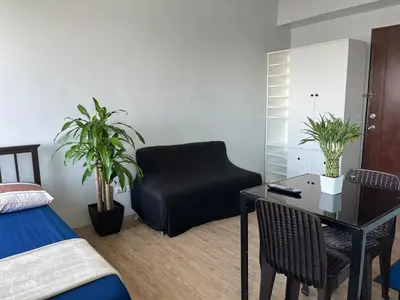a bedroom with a black chair and a desk at Ultimate getaway in Alabang at Anuva Residences in Manila