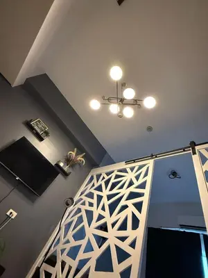 a room with a staircase with a ceiling at Jamellas' Smile Home in Manila