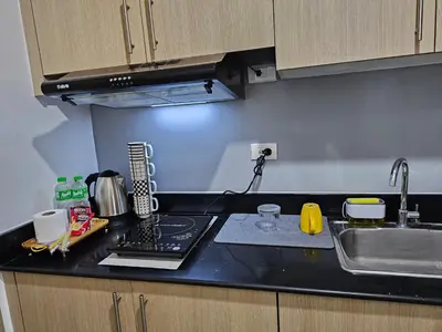 a kitchen with a sink and a counter top at Jamellas' Smile Home in Manila