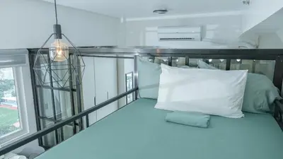 a balcony with a white pillow and a window at Casa Roma Manila in Manila