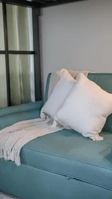 a blue couch with a pillow on top of it at Casa Roma Manila in Manila