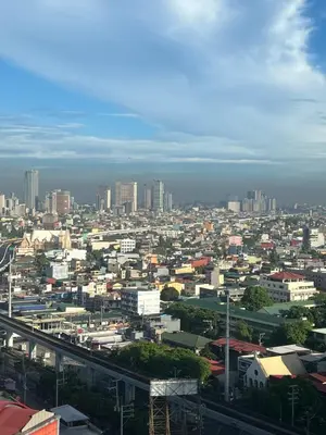 a view of a city with buildings and a bridge at Relaxing Haven at Covent Garden in Manila