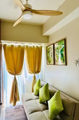 a living room with a couch and a ceiling fan at Chic and Cozy 1BR Shore 3 by SMDC near MOA in Manila
