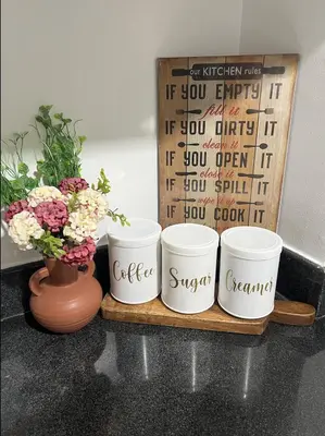 four coffee cups sitting on a shelf next to a vase at 2BR Staycation in front of MOA Near Aiports Entertainment City Ayala Malls Parqal Worldtrade Center PICC Starcity SEA ESCAPE BLISS in Manila