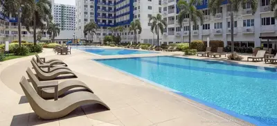 a large swimming pool in a large building at 2BR Staycation in front of MOA Near Aiports Entertainment City Ayala Malls Parqal Worldtrade Center PICC Starcity SEA ESCAPE BLISS in Manila