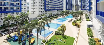 an aerial view of a pool at a resort at 2BR Staycation in front of MOA Near Aiports Entertainment City Ayala Malls Parqal Worldtrade Center PICC Starcity SEA ESCAPE BLISS in Manila