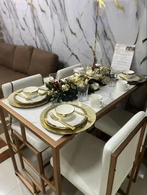a dining room table with a christmas centerpiece at 2BR Staycation in front of MOA Near Aiports Entertainment City Ayala Malls Parqal Worldtrade Center PICC Starcity SEA ESCAPE BLISS in Manila