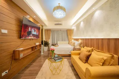 a living room with a couch and a bed at House of Tulips in Air Residences Makati City in Manila