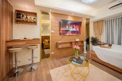 a hotel room with a bed and a bar at House of Tulips in Air Residences Makati City in Manila