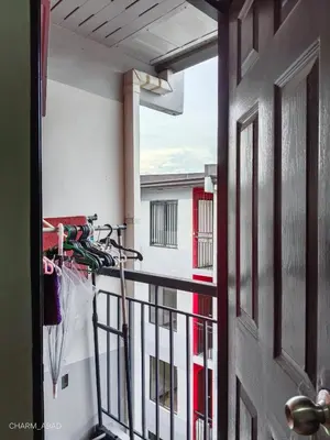 a bike parked on the balcony of a building at Amenadiel & CC - Imus Staycation in Imus