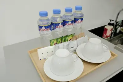 a tray with two cups and plates and bottles of water at STAR CITY 1148 DYNASTEL SHORE Staycation in Manila