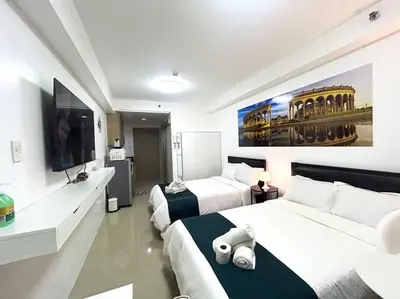 a hotel room with two beds and a flat screen tv at STAR CITY 1148 DYNASTEL SHORE Staycation in Manila