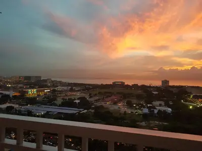 a view of a city with a rainbow in the sky at Studio unit at The Breeze Residence in Manila