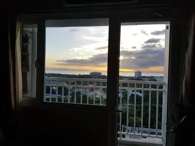 a window with a view of a city skyline at Studio unit at The Breeze Residence in Manila