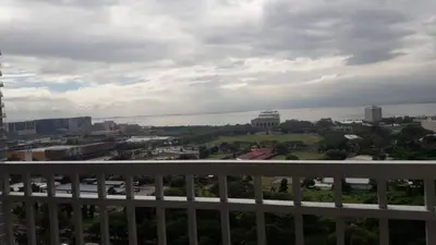 a view of a city from the balcony of a building at Studio unit at The Breeze Residence in Manila