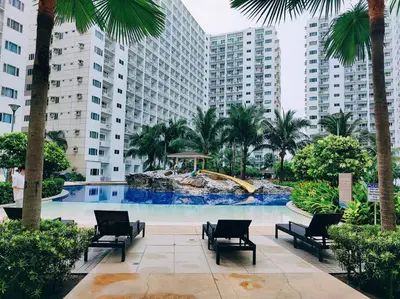 a pool with chairs and a water slide in a city at WORLD TRADE CENTER 959 DYNASTEL SHORE Staycation in Manila