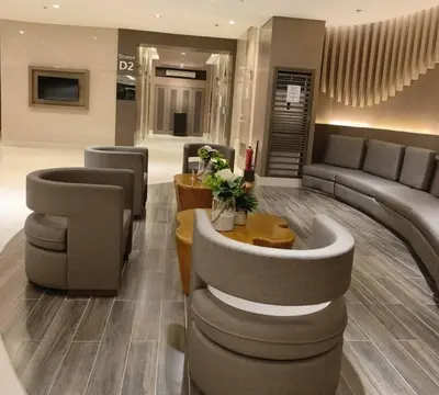 a lobby with a couch and chairs and a table at OKADA Pasay MOA 1257 DYNASTEL SHORE STAYCATION in Manila