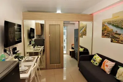 a living room with a couch and a table at NAIA Pasay MOA 1250 Dynastel Shore Staycation in Manila