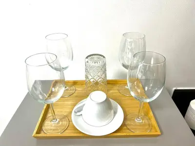 a group of wine glasses and a plate on a table at NAIA Pasay MOA 1250 Dynastel Shore Staycation in Manila