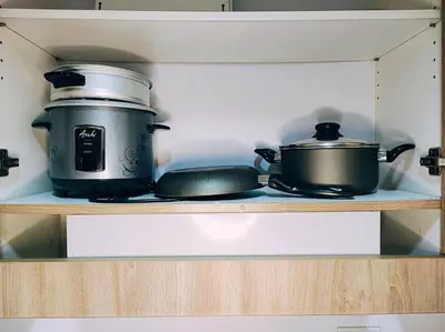 two pots and pans on a shelf in a kitchen at NAIA Pasay MOA 1250 Dynastel Shore Staycation in Manila