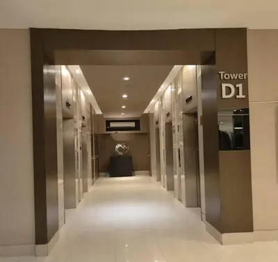 a hallway in a building with a tower dl sign at NAIA Pasay MOA 1250 Dynastel Shore Staycation in Manila