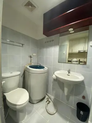 a bathroom with a toilet and a sink at Sea Residences MOA Pasay City - Ruffa's Condotel in Manila