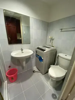 a bathroom with a toilet and a sink at Sea Residences MOA Pasay City - Ruffa's Condotel in Manila