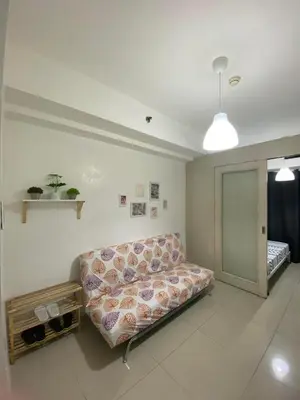 a living room with a couch in a room at Sea Residences MOA Pasay City - Ruffa's Condotel in Manila