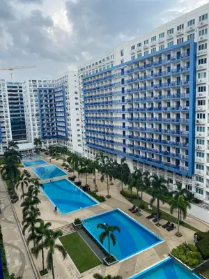 an aerial view of a large building with several pools at Sea Residences MOA Pasay City - Ruffa's Condotel in Manila