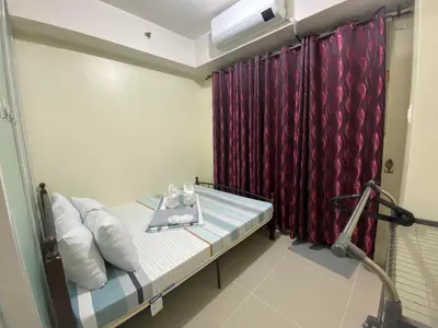a hospital room with a bed and a red curtain at Sea Residences MOA Pasay City - Ruffa's Condotel in Manila