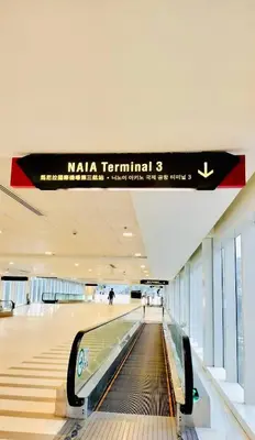 an empty baggage claim area in a mall with a sign at Condotel Across Naia T3 at ONE PALM TREE VILLA CLUSTER B in Manila